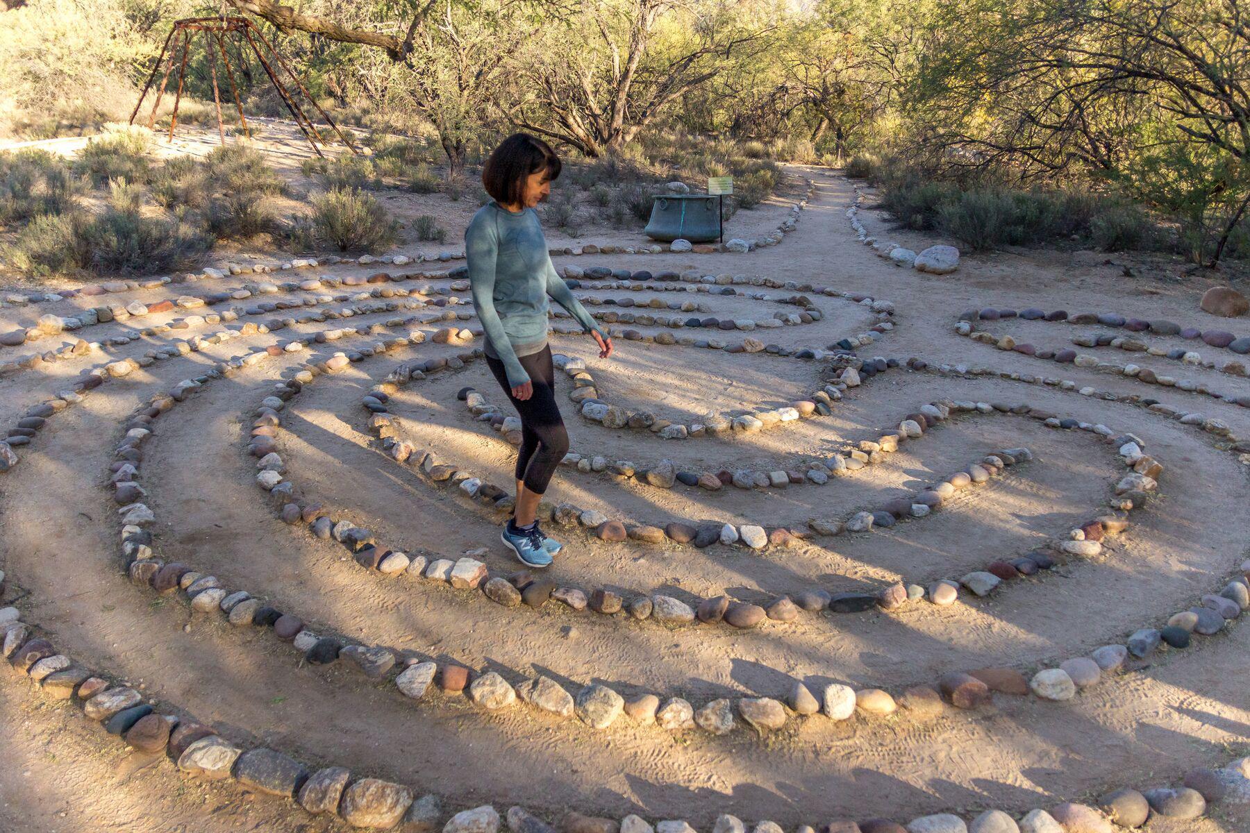 a woman walking through the labyrinth at Canyon Ranch Tucson Wellness + Spa Resort