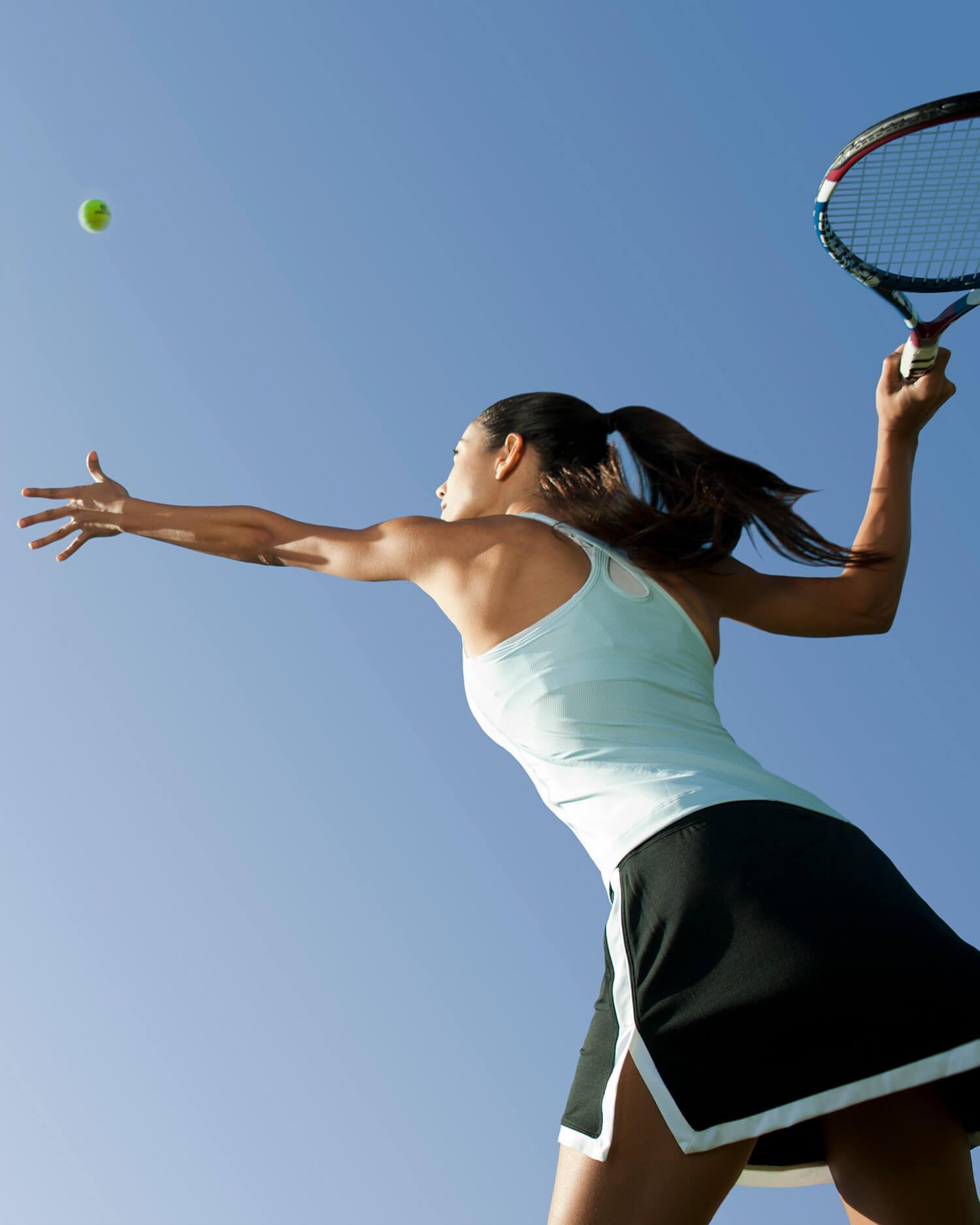 a woman serving in tennis