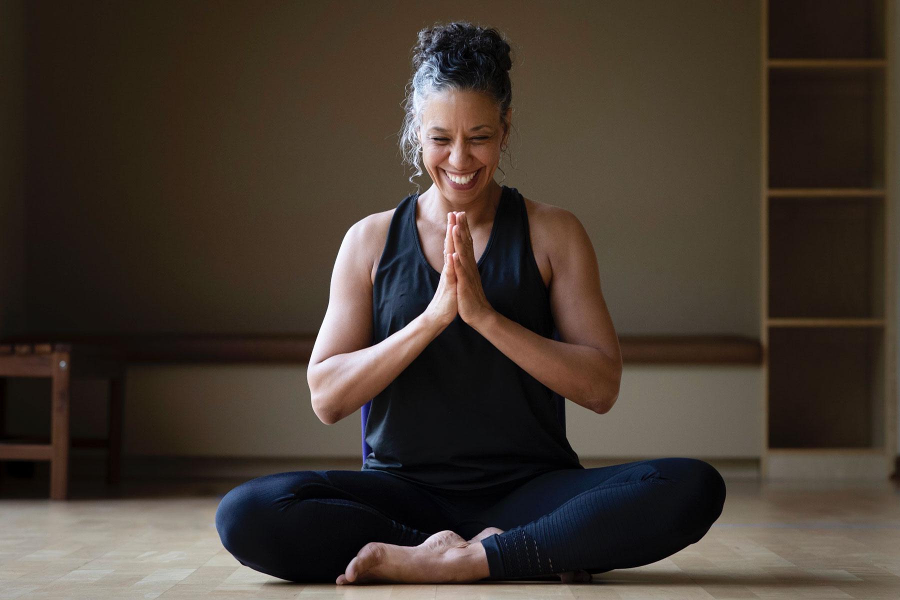 Woman smiling while meditating.