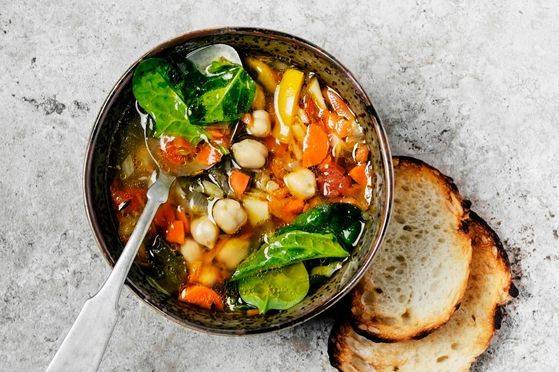 Overhead view of a bowl of minestrone soup.