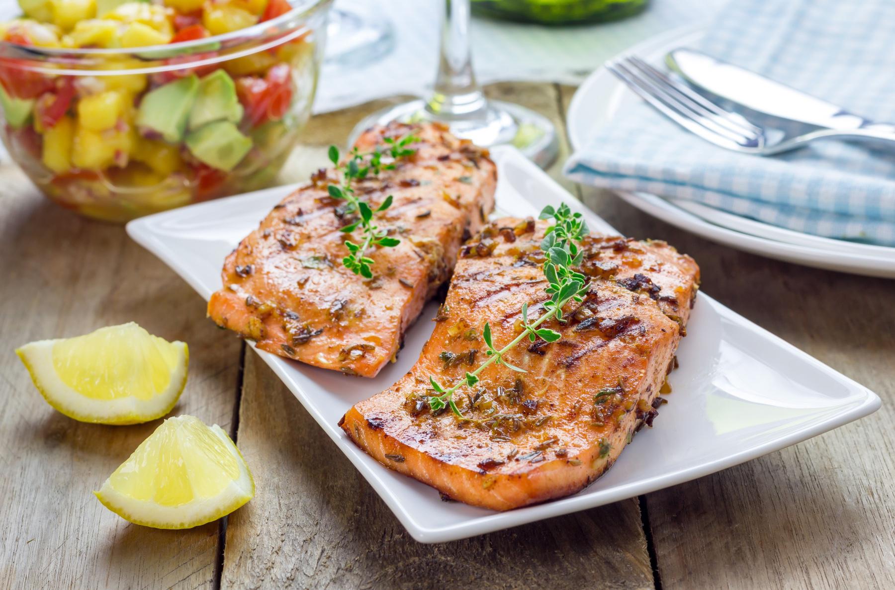 A plate of Mongolian marinated salmon with apple cranberry slaw.
