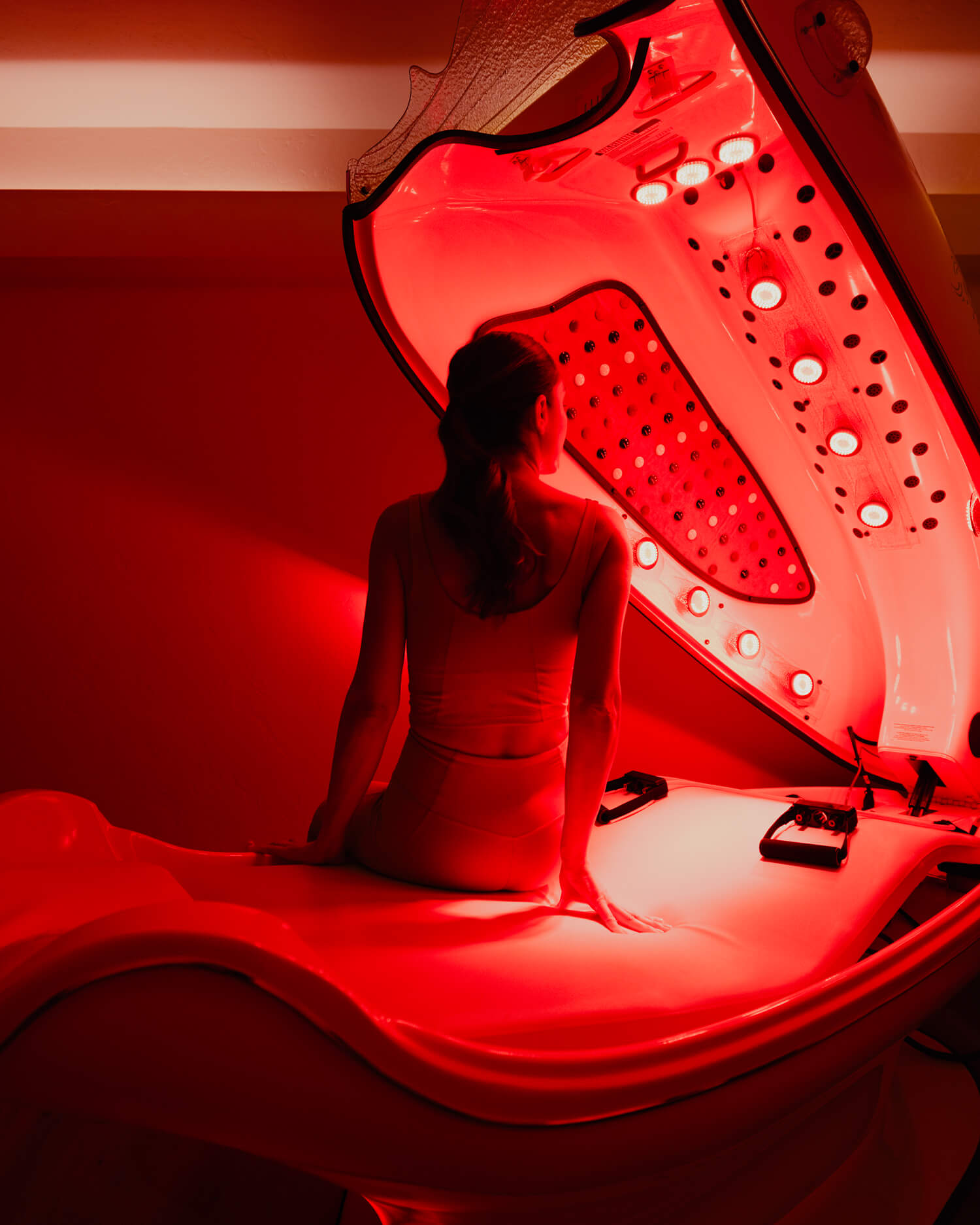 A man in a read light therapy bed