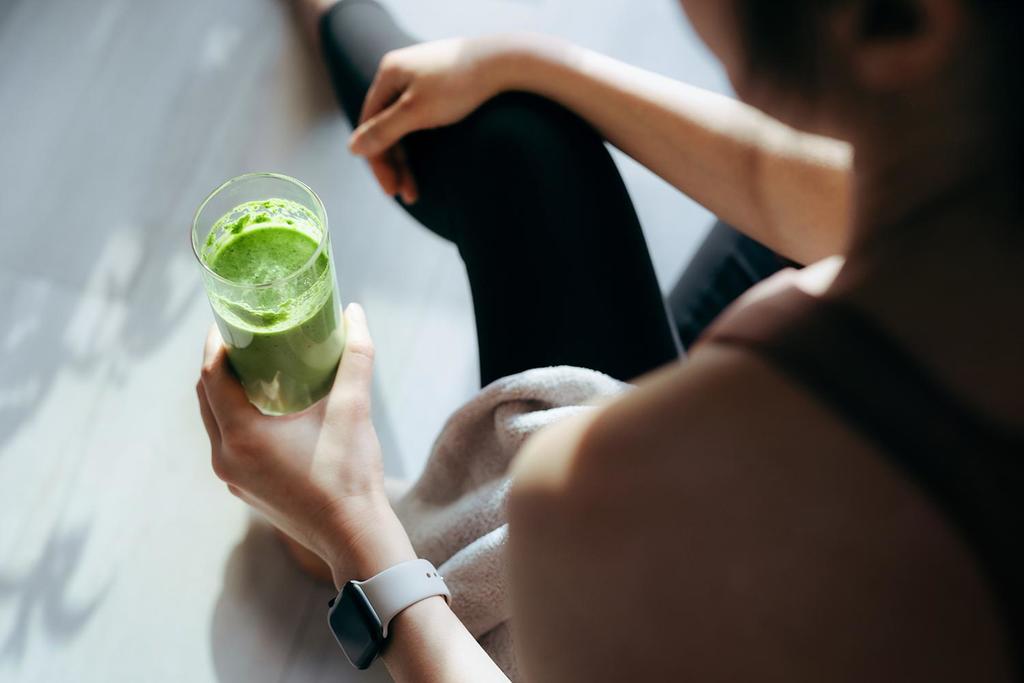 A woman drinking a smoothie