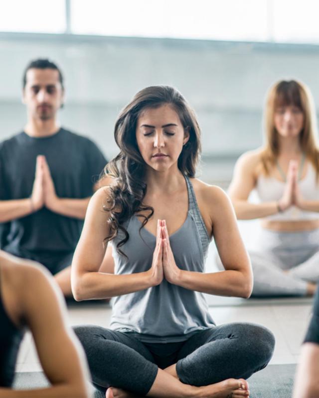 A group meditating at Canyon Ranch Fort Worth Wellness Club + Spa