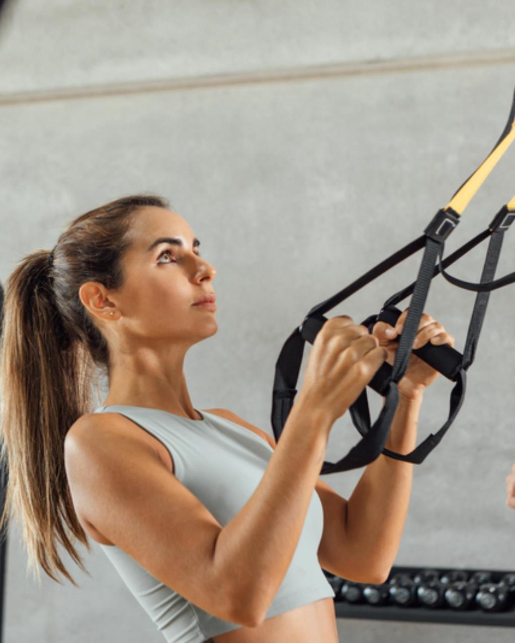 Woman using TRX bands for a HIIT workout at Canyon Ranch Fitness Club in Fort Worth Texas