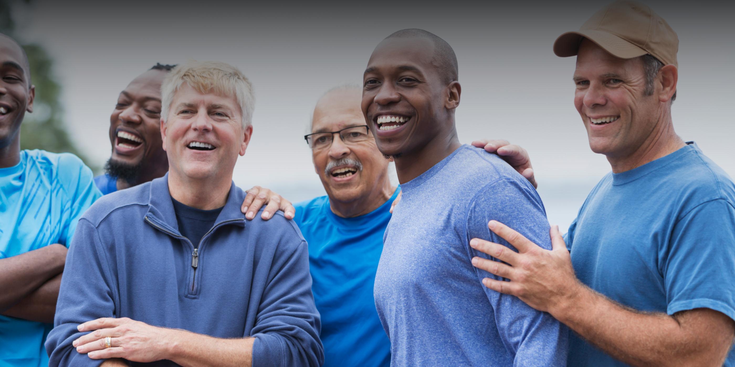 A group of men having a laugh outdoors