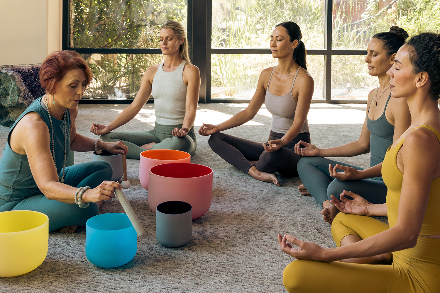a group of women listening to sound bowls