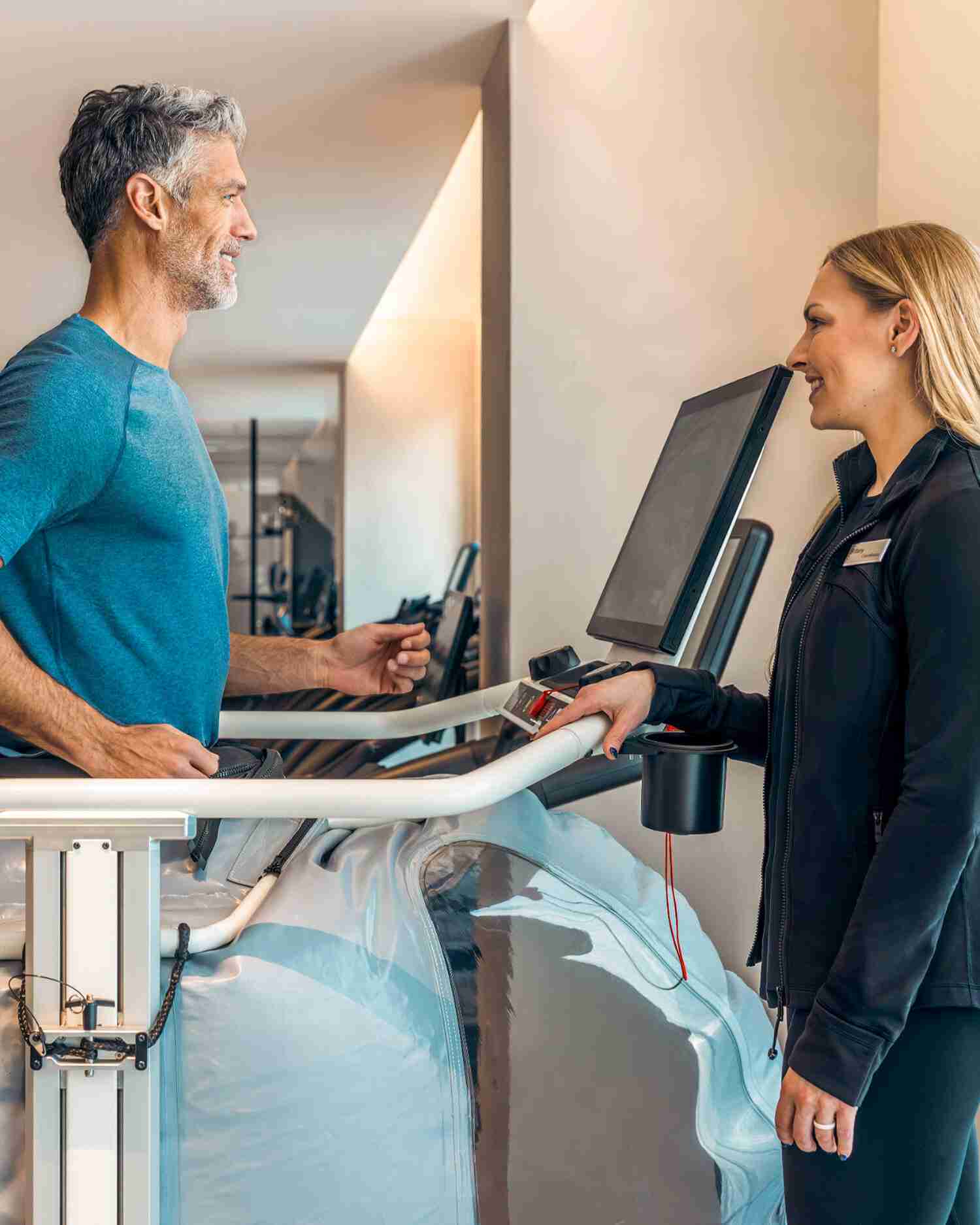 A man on a treadmill with a performance scientist