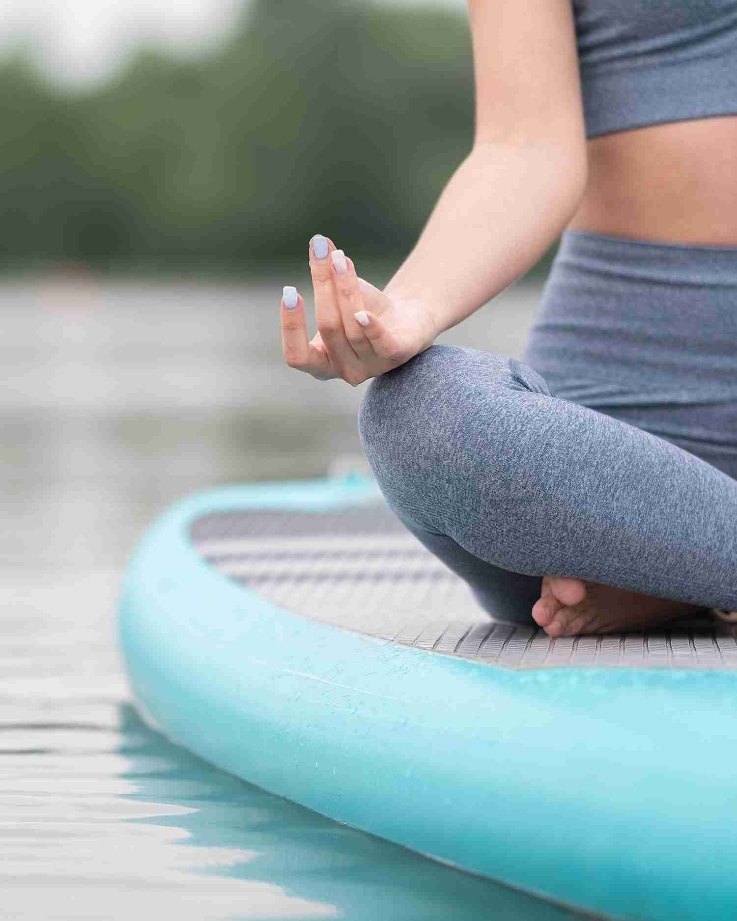 A woman sitting on a paddleboard