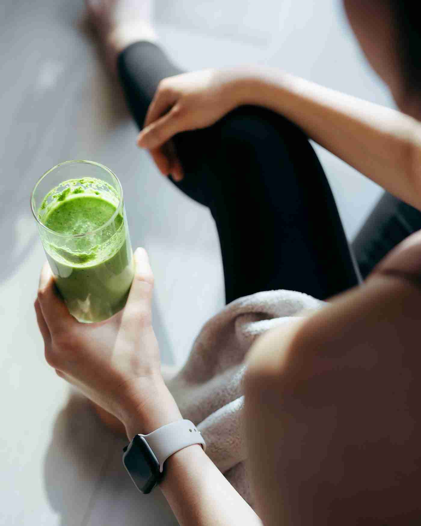 A woman drinking a smoothie