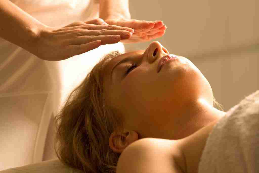 A woman getting a reiki healing