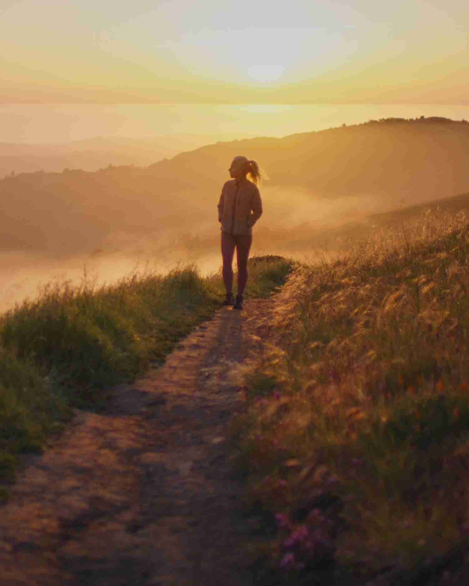A woman walking on a trail