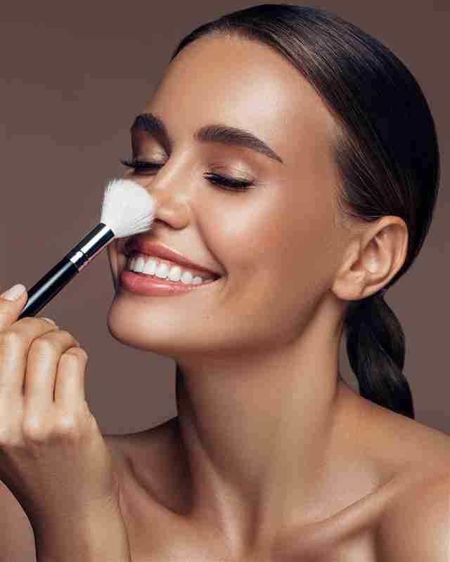 a woman applying makeup