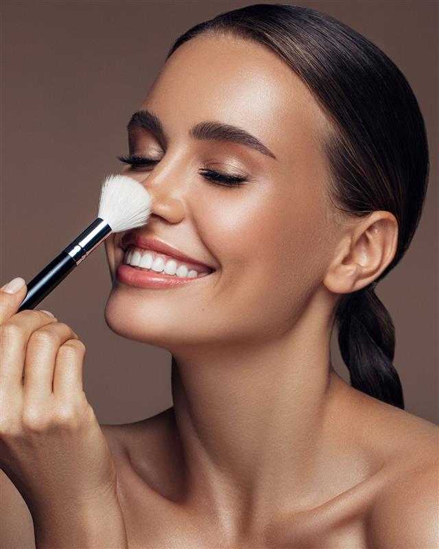 a woman applying makeup