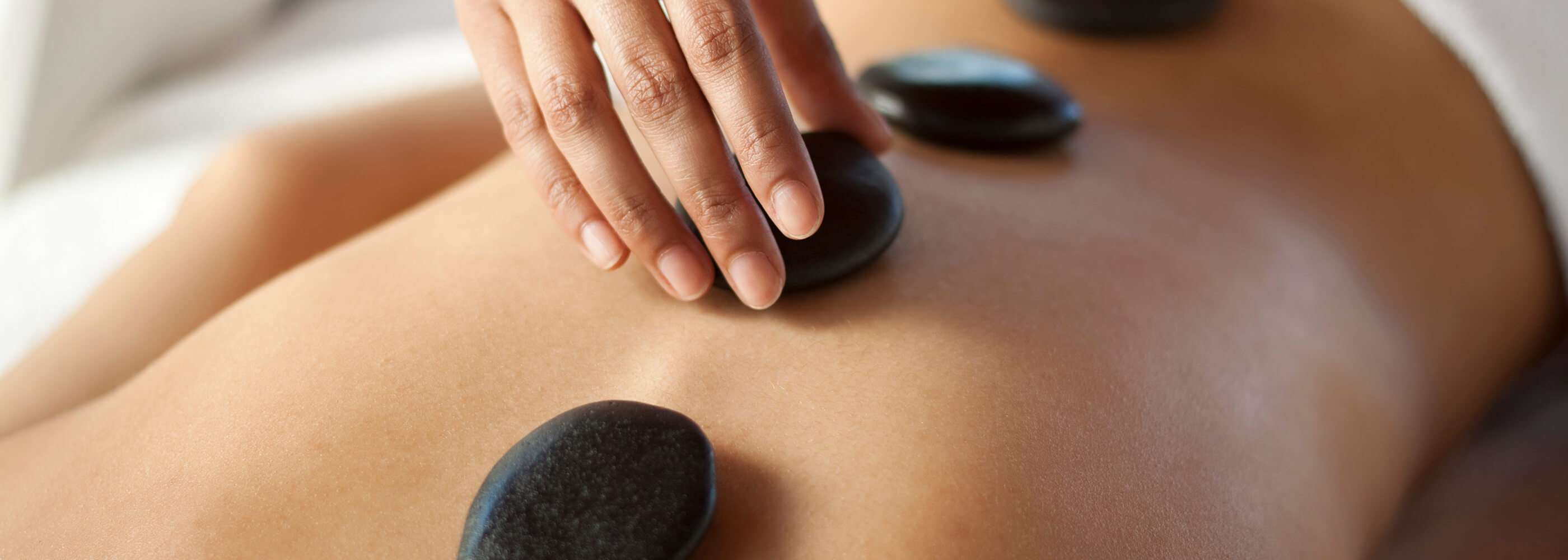 A woman getting a hot stone massage