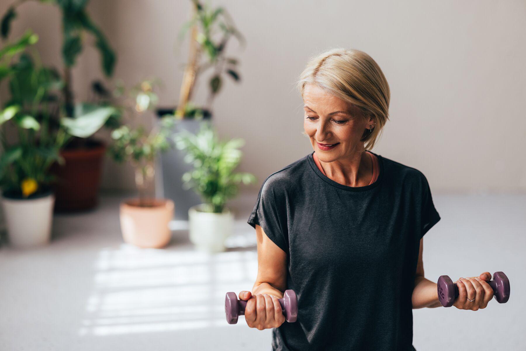 A mature woman building muscle with dumbbells