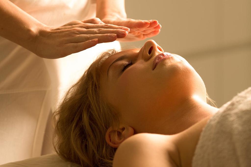 A woman getting a reiki healing