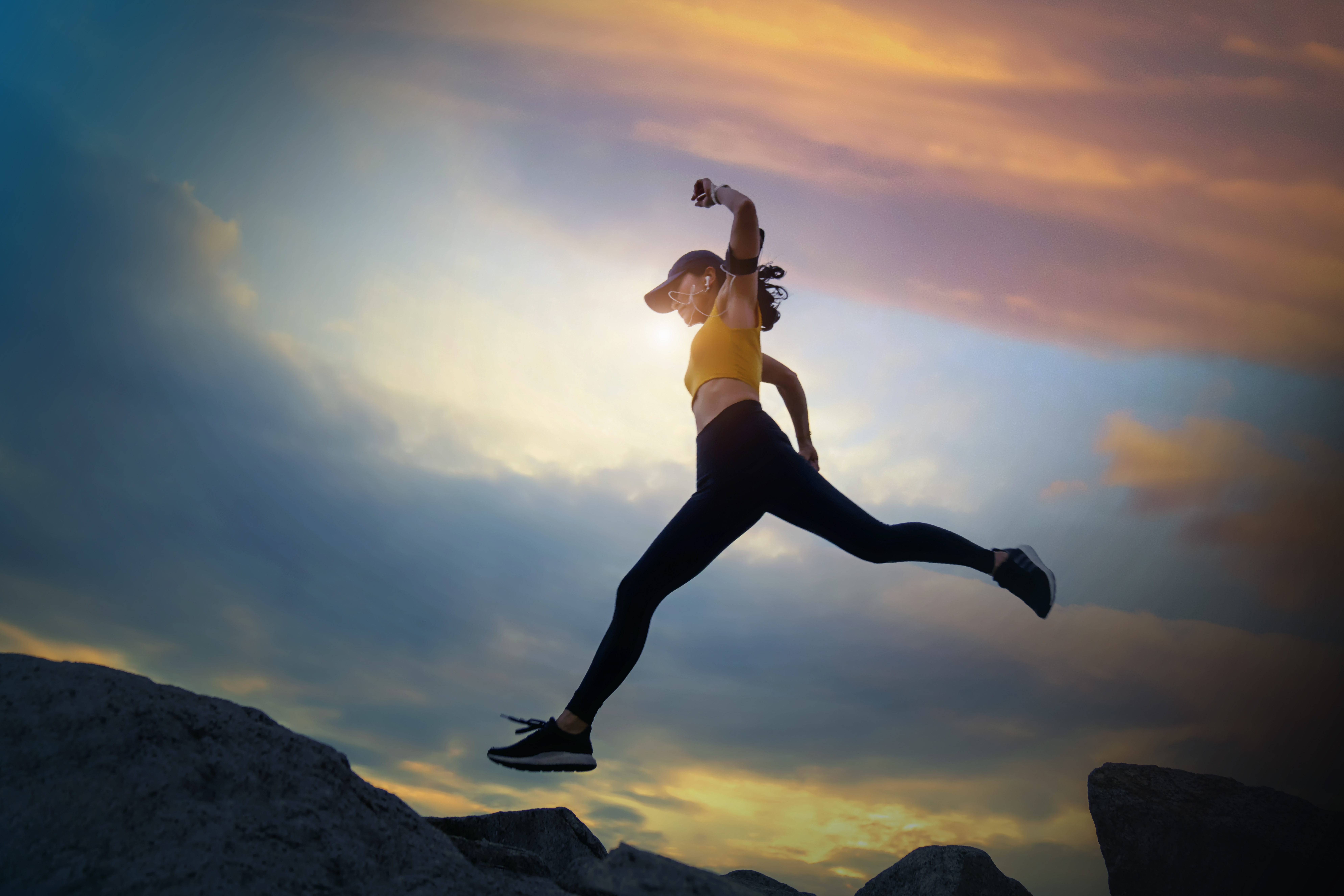 A woman leaping on rocks