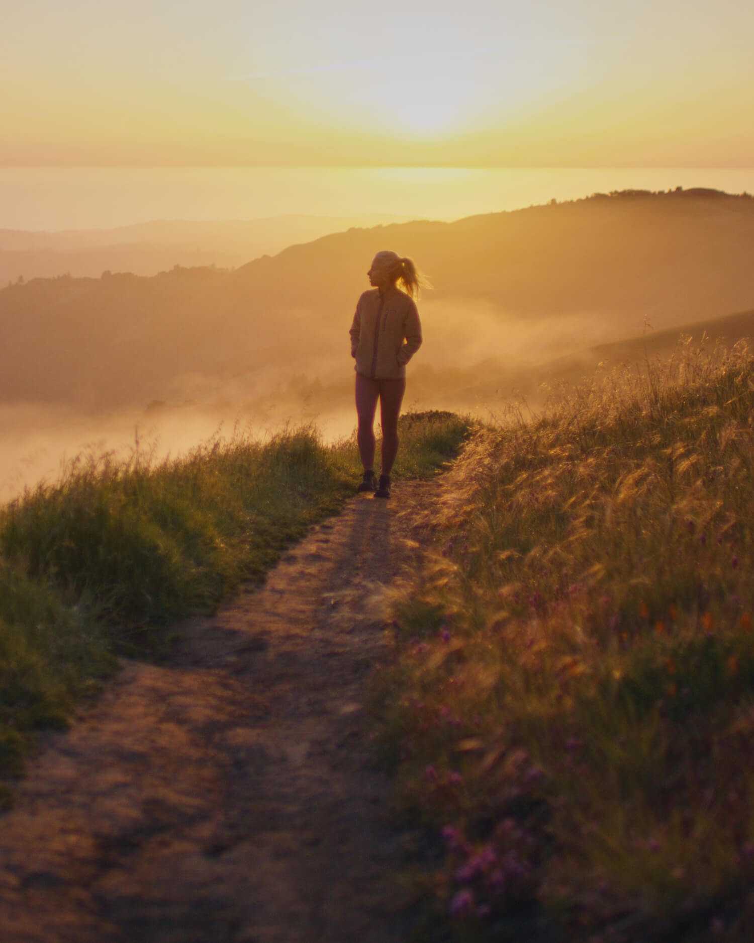 A woman walking on a trail
