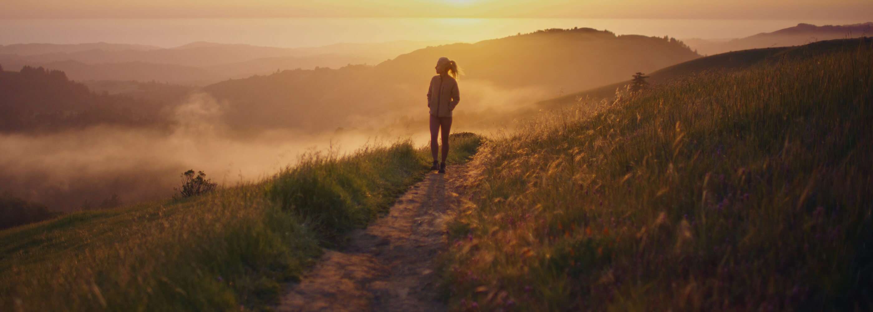 A woman walking on a trail