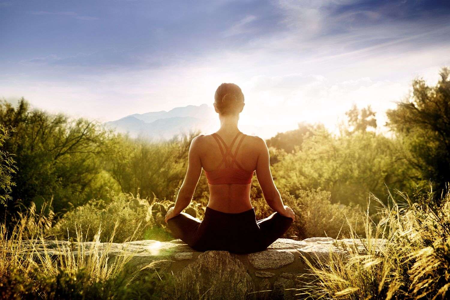 A girl meditating in the sunshine in the Sonoran Desert