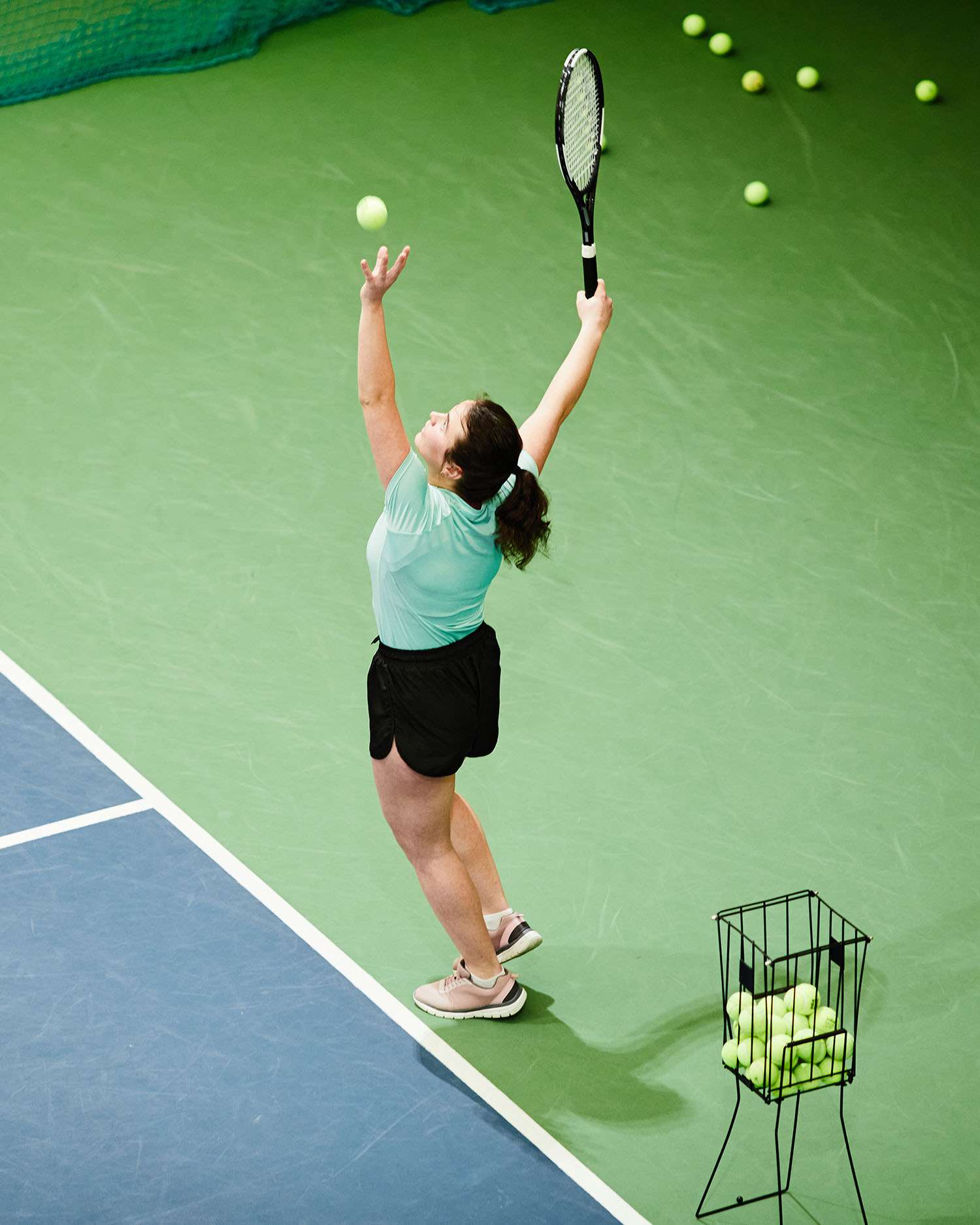 a woman serving a tennis ball