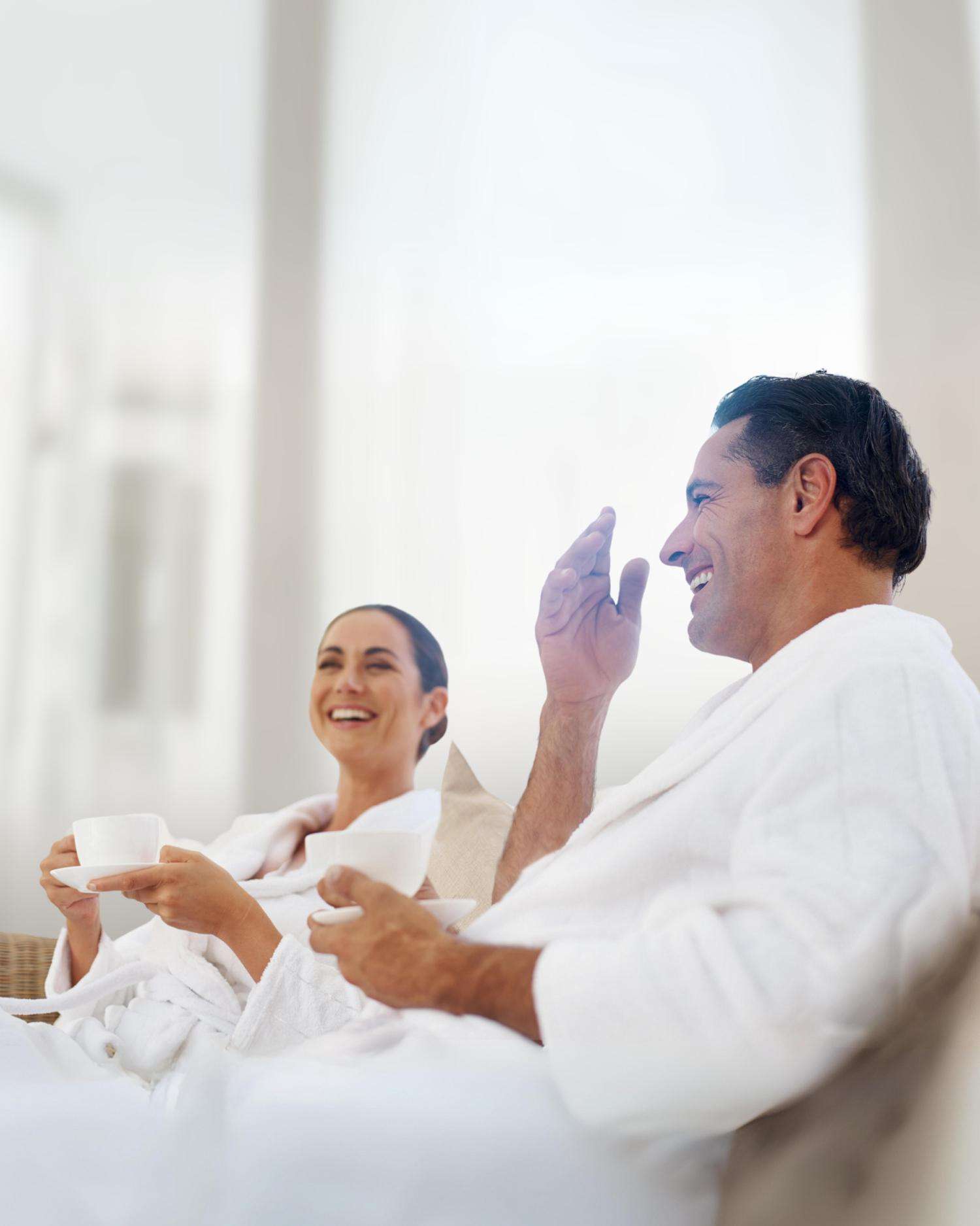 couple wearing robes and relaxing in spa