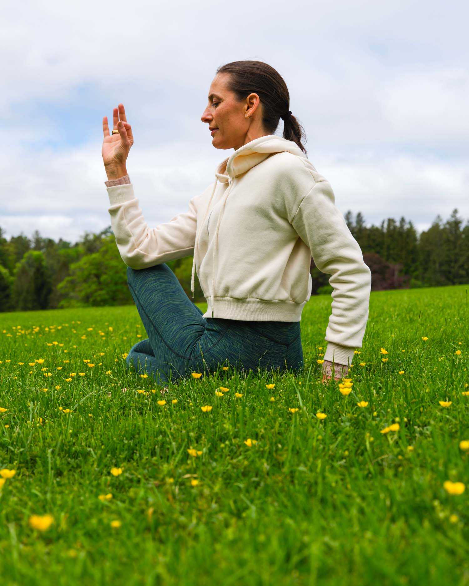 a woman doing yoga in a field of flowers