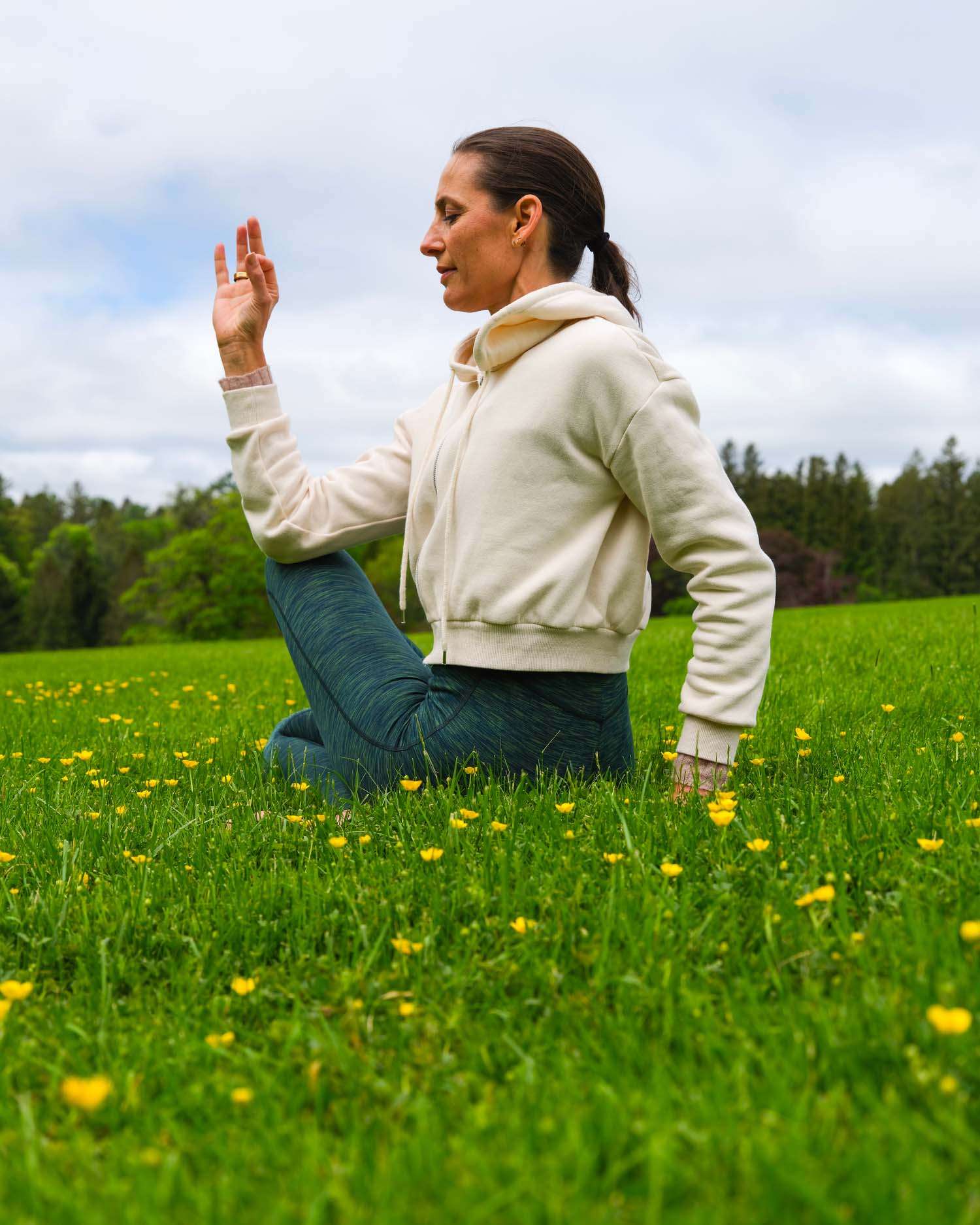 a woman doing yoga in a field of flowers